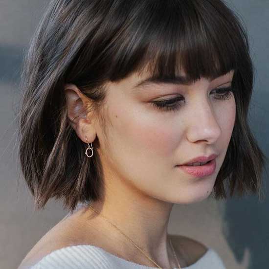 Fille avec une coupe de cheveux à la mode avec une frange